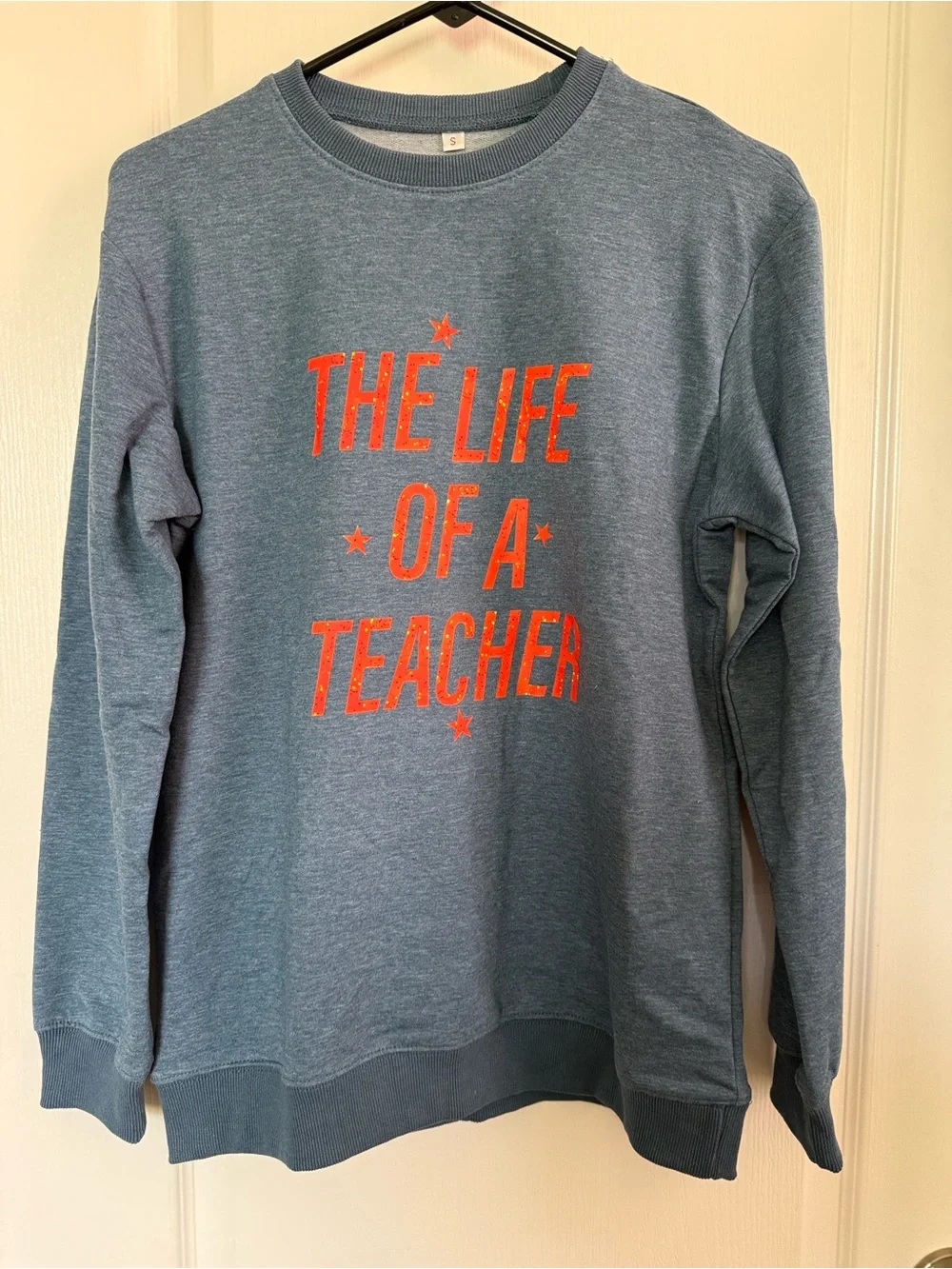 Women’s Crewneck Sweatshirt in Heather Blue with Orange Text
